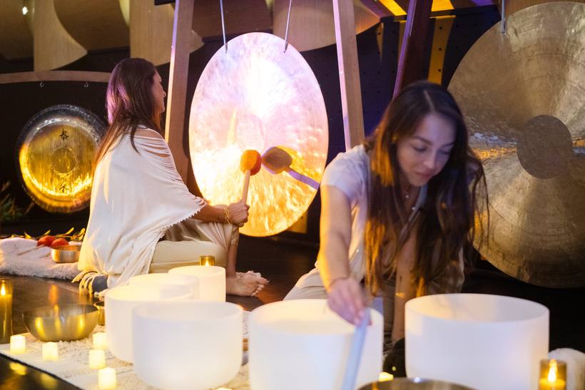 Facilitadoras tocando gongs y cuencos de cuarzo